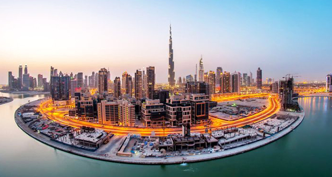 Illuminated Dubai skyline at dusk